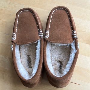 Cozy moccasin slippers, lithe brown with fur inside. Slip into a cloud!